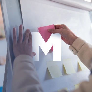 Hands placing a sticky note — temporary unlicensed stock preview, pending a licensed replacement